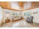 Living room with wood ceiling, tiled floor, and comfy seating at 604 Pennsylvania Ave, Crystal Beach, FL 34681