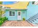 Welcoming patio area with brick pavers and a white door at 604 Pennsylvania Ave, Crystal Beach, FL 34681