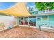 Relaxing patio with brick paving, shade sail, and comfortable seating at 604 Pennsylvania Ave, Crystal Beach, FL 34681