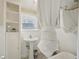 Clean bathroom featuring a pedestal sink, built-in shelves, and a shower with a curtain at 612 12Th S Ave, St Petersburg, FL 33701