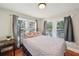Cozy bedroom with a decorative metal bed frame and warm natural lighting from multiple windows at 612 12Th S Ave, St Petersburg, FL 33701