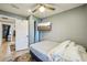 Comfortable bedroom with a ceiling fan, mounted TV, and a glimpse into the hallway and adjacent rooms at 612 12Th S Ave, St Petersburg, FL 33701