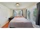 Comfortable bedroom with hardwood floors, dual windows, and a cozy bed at 612 12Th S Ave, St Petersburg, FL 33701