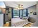 Bedroom featuring a ceiling fan, wall decor, and natural light through windows at 612 12Th S Ave, St Petersburg, FL 33701