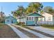 Charming home featuring light blue painted wood siding and a long concrete driveway at 612 12Th S Ave, St Petersburg, FL 33701