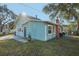 Charming blue home with a sunny front yard, featuring mature trees and a welcoming entrance at 612 12Th S Ave, St Petersburg, FL 33701