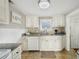 Functional kitchen boasting white cabinetry, tiled floors, and stainless steel appliances at 612 12Th S Ave, St Petersburg, FL 33701