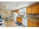 Well-lit kitchen featuring wood cabinets, granite countertops, tile backsplash, and white appliances at 612 12Th S Ave, St Petersburg, FL 33701