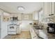 Bright kitchen with granite countertops, stainless steel microwave, tile backsplash, and ample cabinet space at 612 12Th S Ave, St Petersburg, FL 33701