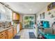 Bright kitchen featuring wood cabinets, granite countertops, and a sliding glass door leading to the backyard at 612 12Th S Ave, St Petersburg, FL 33701