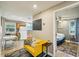 Cozy living room features tile flooring, a bright yellow couch and an open doorway to the bedroom and kitchen at 612 12Th S Ave, St Petersburg, FL 33701