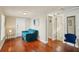 Living room with hardwood floors, a comfortable blue couch, and access to bathroom at 612 12Th S Ave, St Petersburg, FL 33701