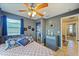 Inviting main bedroom with a ceiling fan, a blue accent wall, and an ensuite bathroom at 612 12Th S Ave, St Petersburg, FL 33701