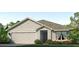 One-story home with a light beige exterior, gray roof, and landscaped front yard at 6123 Distant Haze Pl, Palmetto, FL 34221