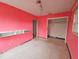 Simple bedroom with pink walls, a closet, and wall-mounted shelving at 6692 17Th N Way, St Petersburg, FL 33702