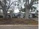 Ranch-style home with mature trees and a covered entryway at 6692 17Th N Way, St Petersburg, FL 33702