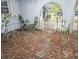 Small front yard with mature trees and a white picket gate at 6692 17Th N Way, St Petersburg, FL 33702