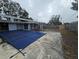 Backyard view featuring a large pool with a blue cover at 6692 17Th N Way, St Petersburg, FL 33702