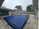 Residential pool with a dark blue safety cover at 6692 17Th N Way, St Petersburg, FL 33702