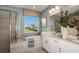 Elegant bathroom with a soaking tub, walk-in shower, and dual vanity at 710 Sky Shade Dr, Apollo Beach, FL 33572