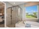 Spa-like bathroom with a large shower and garden views at 710 Sky Shade Dr, Apollo Beach, FL 33572