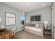 Cozy bedroom with a daybed, desk, and large artwork at 710 Sky Shade Dr, Apollo Beach, FL 33572