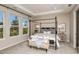Spacious bedroom with a large four-poster bed and plenty of natural light at 710 Sky Shade Dr, Apollo Beach, FL 33572
