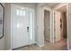 Bright entryway with white door and wood-look tile floors at 710 Sky Shade Dr, Apollo Beach, FL 33572