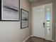 Light and airy entryway with white door and modern art at 710 Sky Shade Dr, Apollo Beach, FL 33572