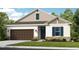 One-story home with brown garage door and blue shutters at 710 Sky Shade Dr, Apollo Beach, FL 33572