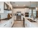 White kitchen with stainless steel appliances and island at 710 Sky Shade Dr, Apollo Beach, FL 33572