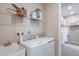 Well-equipped laundry room with washer, dryer, and utility sink at 710 Sky Shade Dr, Apollo Beach, FL 33572