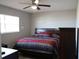 King-size bed, dresser, and ceiling fan in this bedroom at 711 E Brockton Pl, Sun City Center, FL 33573