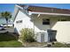Rear view of house showing AC unit and landscaping at 711 E Brockton Pl, Sun City Center, FL 33573
