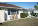 Side view of house showcasing windows and landscaping at 711 E Brockton Pl, Sun City Center, FL 33573