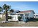 Front view of charming house with palm tree at 711 E Brockton Pl, Sun City Center, FL 33573