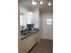 Kitchen with white cabinets, double sink, and stainless steel dishwasher at 711 E Brockton Pl, Sun City Center, FL 33573