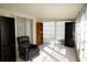 Bright sunroom with tiled floor, comfy seating, and ample storage at 711 E Brockton Pl, Sun City Center, FL 33573