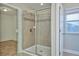 Large walk-in shower with glass enclosure and tile surround at 8044 Lago Mist Way, Wesley Chapel, FL 33545
