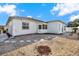 Landscaped backyard with gravel, stepping stones, and privacy fence at 9445 Barnstead Ln, Port Richey, FL 34668