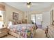 Spacious bedroom with floral bedding and access to sunroom at 9445 Barnstead Ln, Port Richey, FL 34668