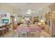 Bright dining room with table and chairs, view into living room and kitchen at 9445 Barnstead Ln, Port Richey, FL 34668