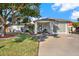 Single-story home with landscaped yard, driveway, and mature tree at 9445 Barnstead Ln, Port Richey, FL 34668