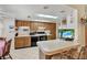 Kitchen with wood cabinets, breakfast bar and view into dining area at 9445 Barnstead Ln, Port Richey, FL 34668