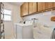 Functional laundry room with washer, dryer, and storage at 9445 Barnstead Ln, Port Richey, FL 34668