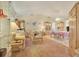 Spacious living room with light colored furniture and view of dining area at 9445 Barnstead Ln, Port Richey, FL 34668