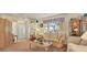Living room with entryway, couches, and display cabinets at 9445 Barnstead Ln, Port Richey, FL 34668