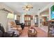 Relaxing living room with comfortable seating and access to sunroom at 9445 Barnstead Ln, Port Richey, FL 34668