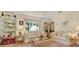 Living room with beige couches, coffee table, and display cabinets at 9445 Barnstead Ln, Port Richey, FL 34668