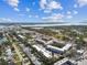 Aerial view showcasing condo near a scenic waterfront, lush greenery, and highways at 9945 47Th N Ave # 206, St Petersburg, FL 33708